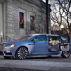 A photo of a blue Lincoln Continental with its suicide doors open.